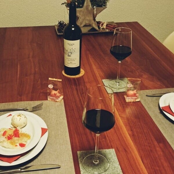 Food, a bottle of organic Georgian red wine and two glasses on a table